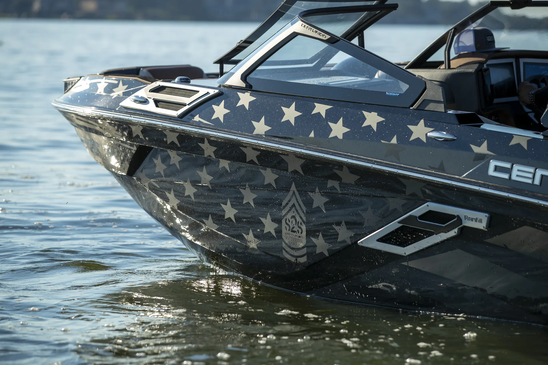 A wakesurf boat with an american flag on the side.