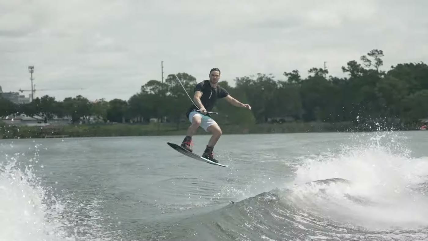 A man is riding a wakeboard on a lake.
