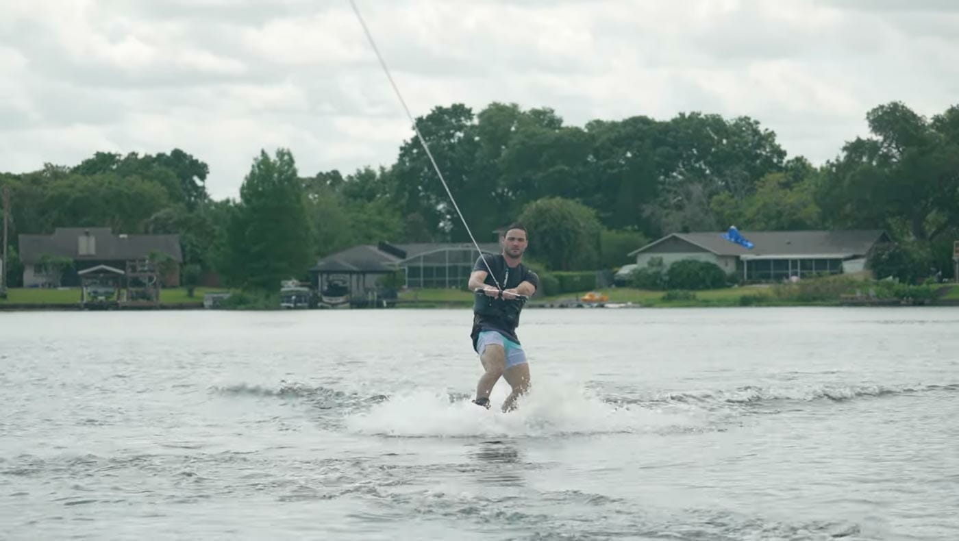 A man wakeboarding on a lake.