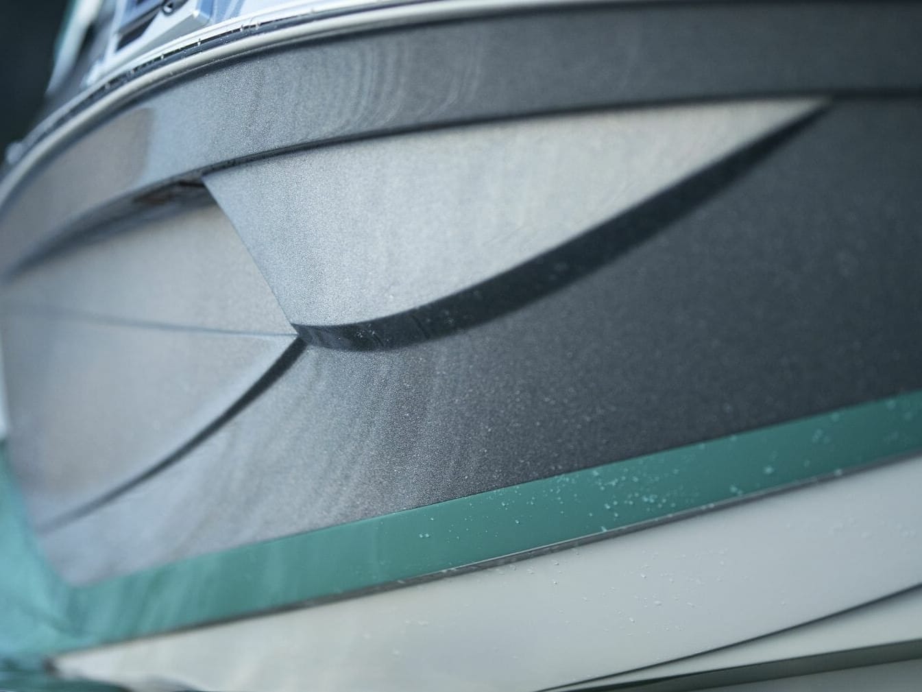 A close up of the front of a wakesurf boat.