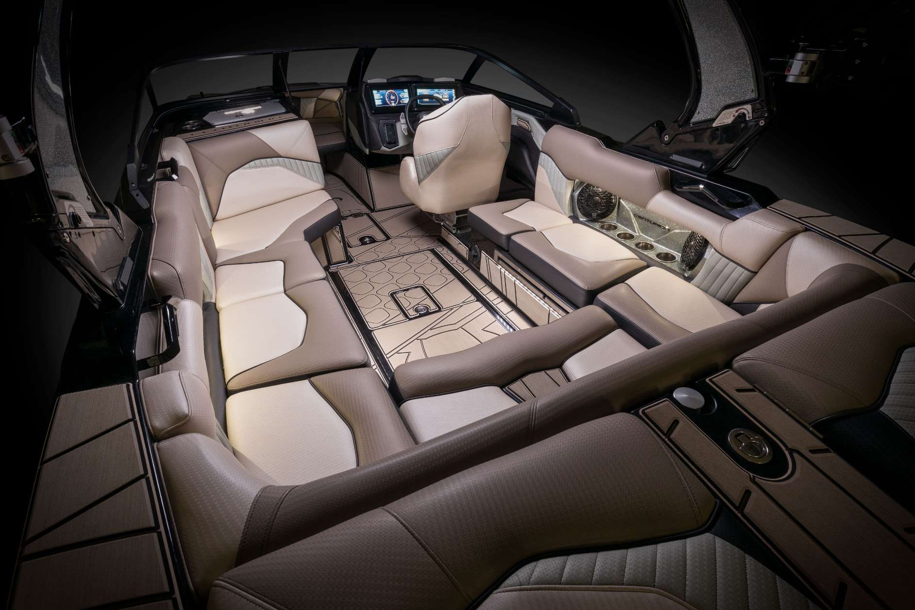 The interior of a wakesurf boat with leather seats.