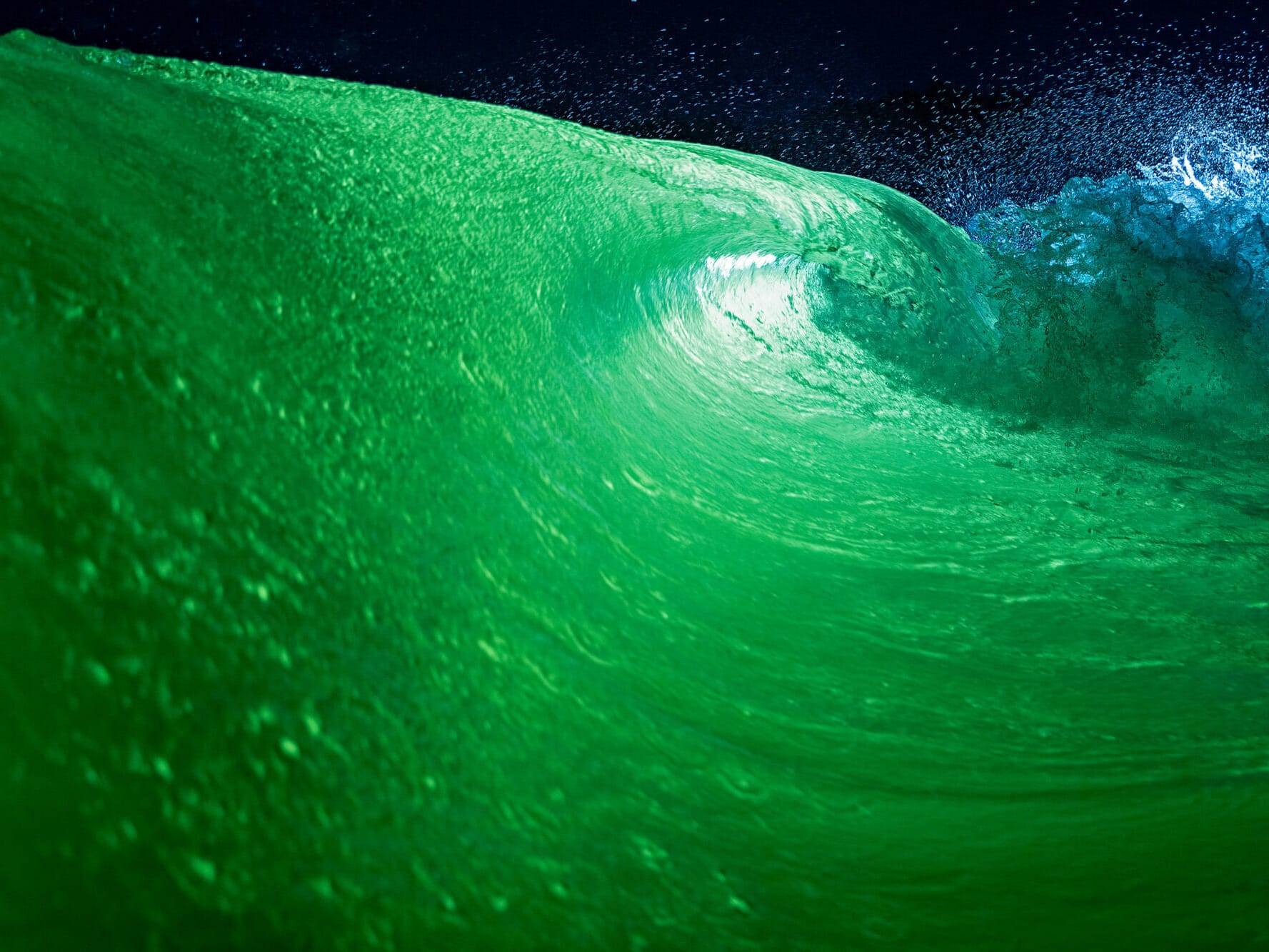 A green wave created by a wakesurf boat.