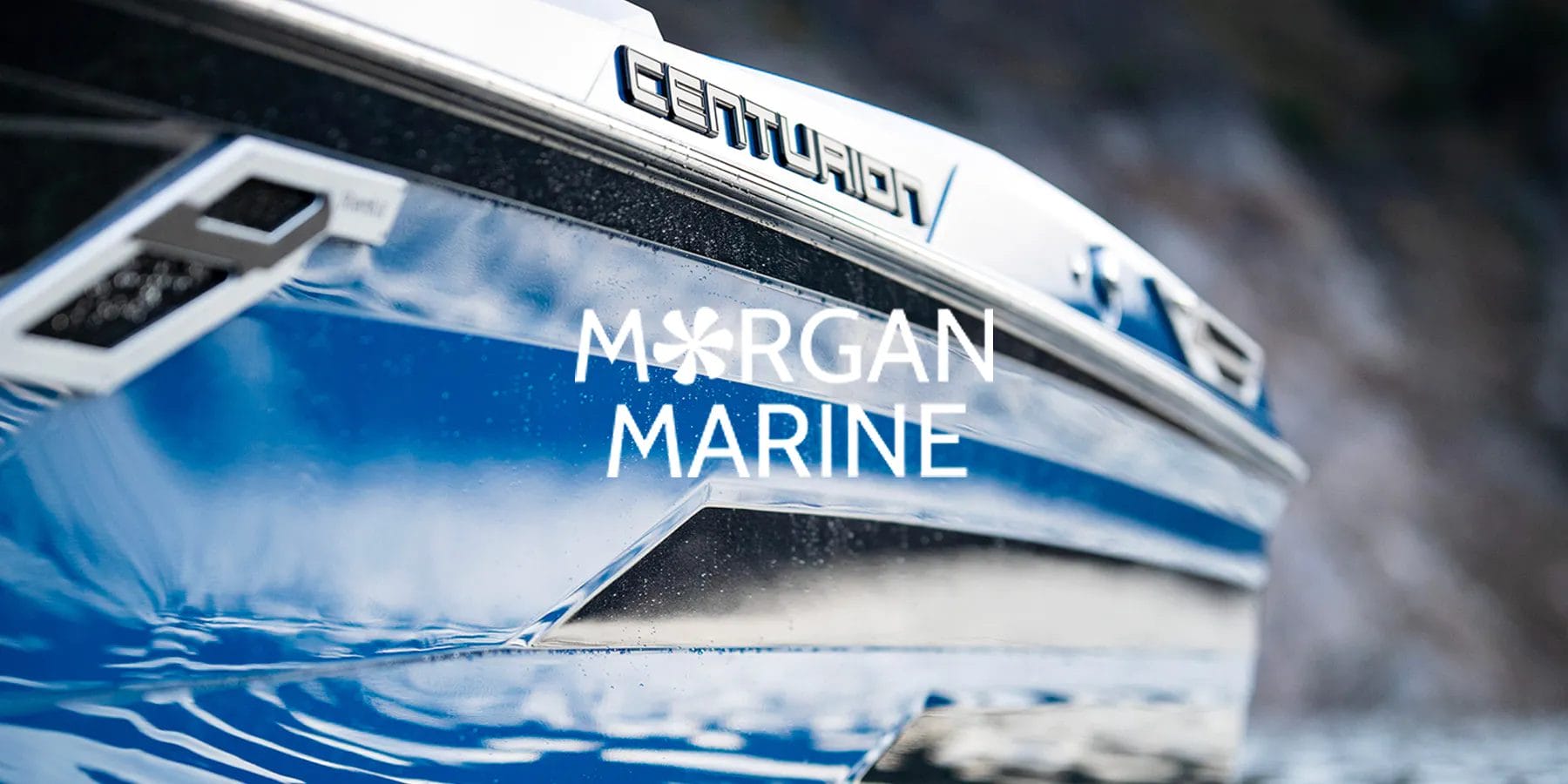 A blue wakesurf boat with the words margan marine on it.