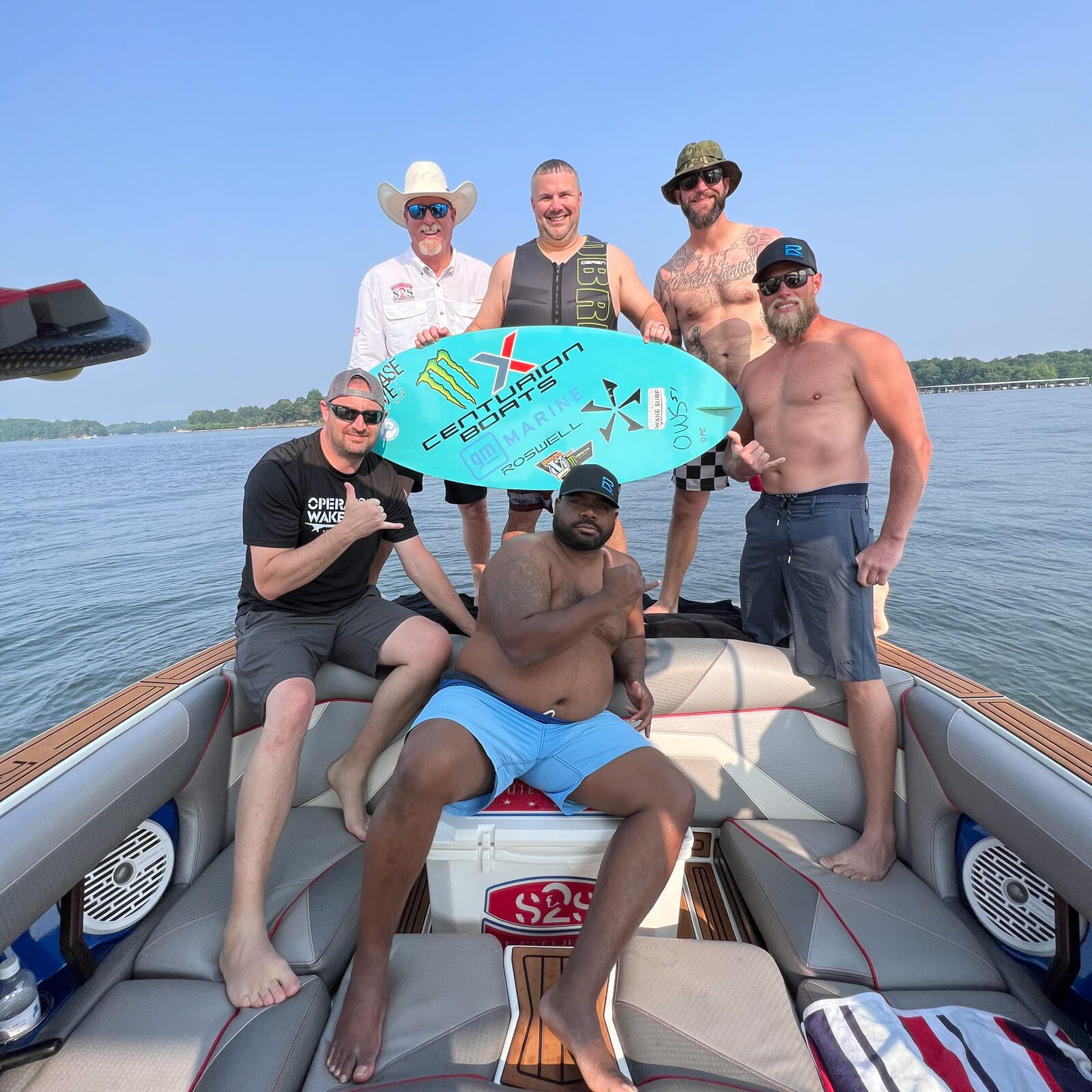 A wakesurf boat with a group of men.
