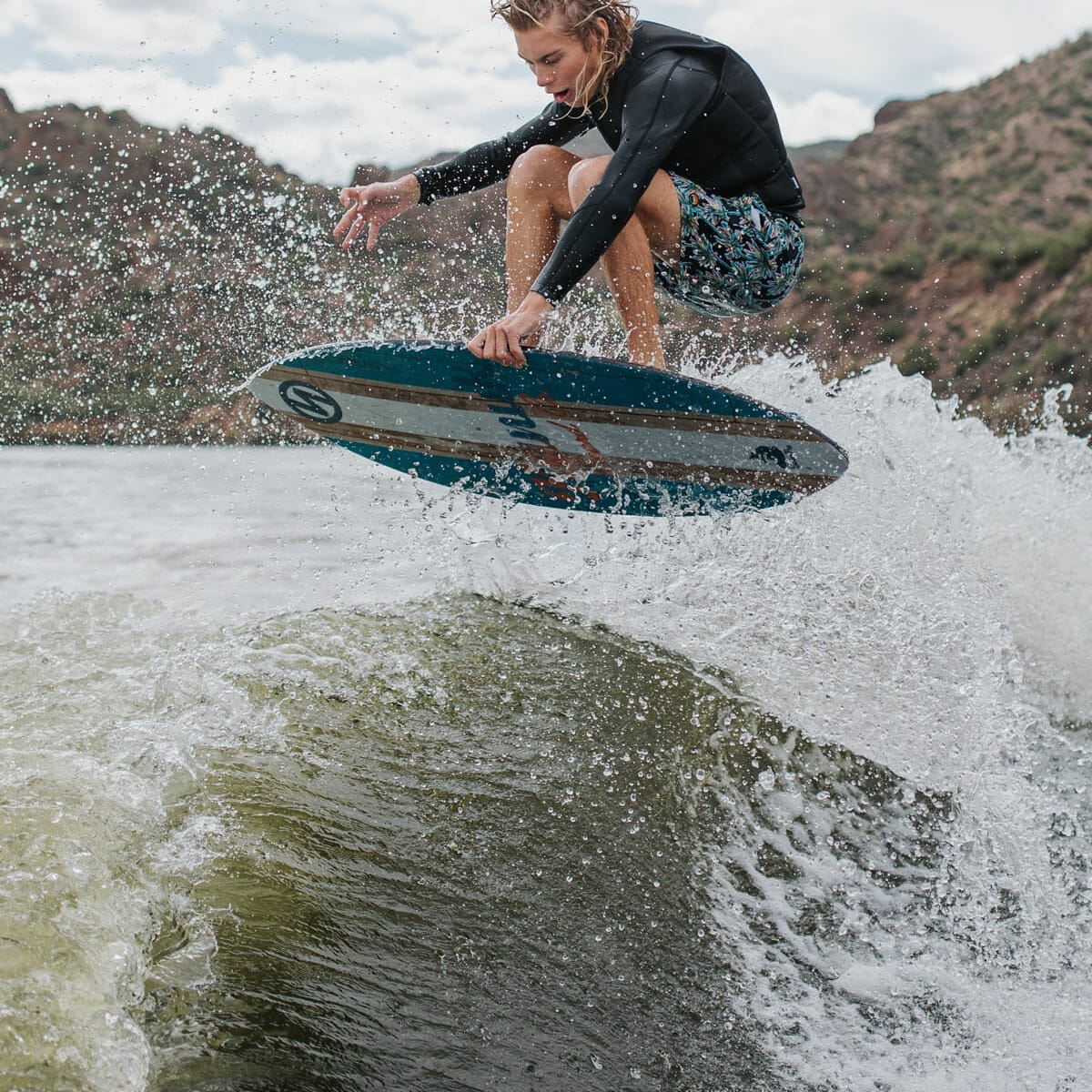 A man rides a wakesurf board.