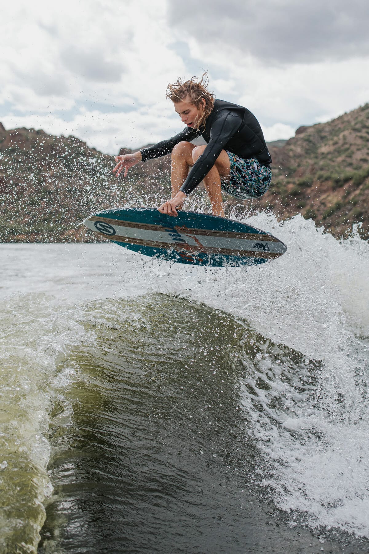 A man rides a wakesurf board.