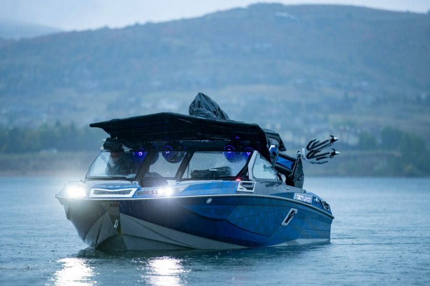 A boat equipped with lights on the water perfect for wakesurfing.