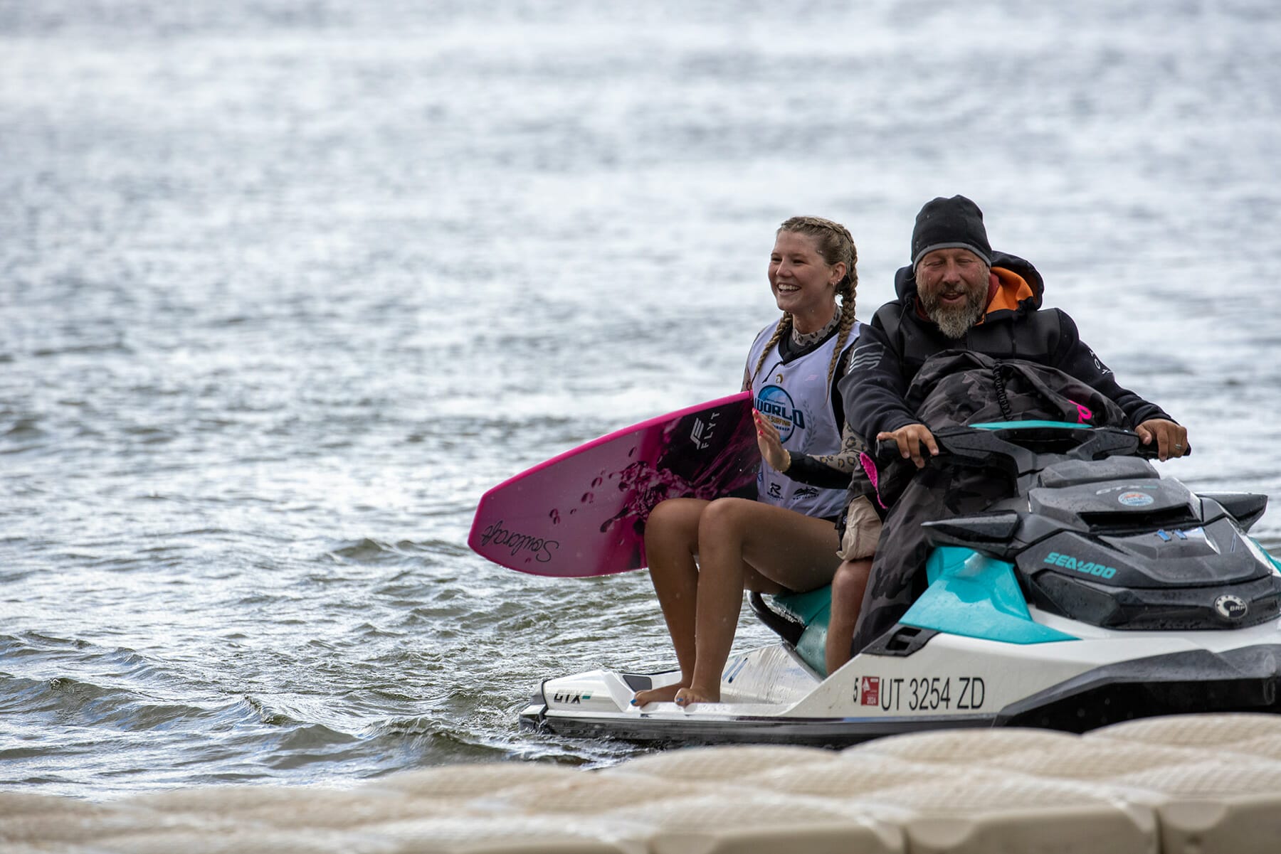 A man and woman riding a jet ski in the water.