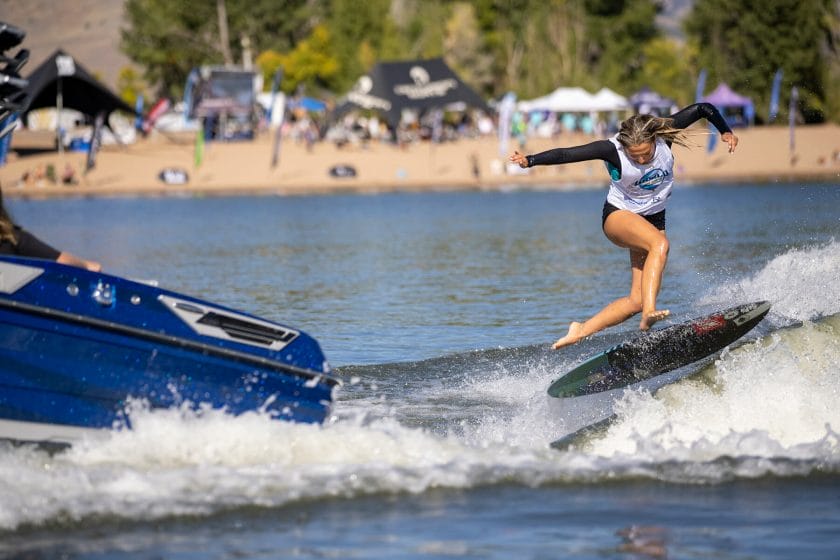 2024 WWSC Day 2 Recap includes a woman riding a surfboard on a lake.