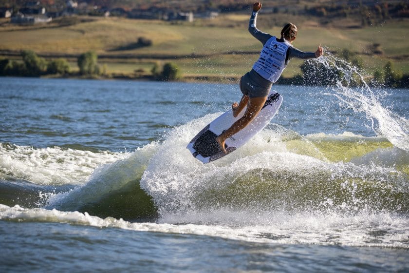 2024 WWSC Day 2 Recap: A man is riding a wave on a surfboard.