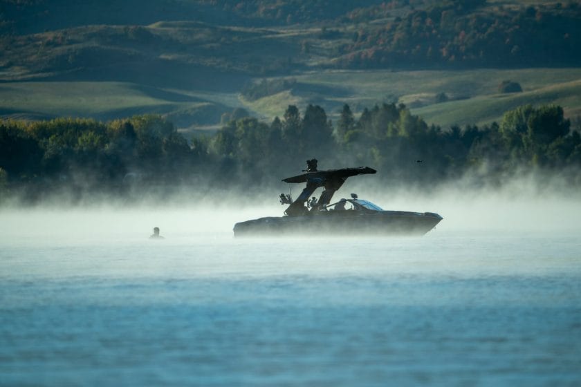 2024 WWSC Day 2 Recap: A misty lake scene with a boat.