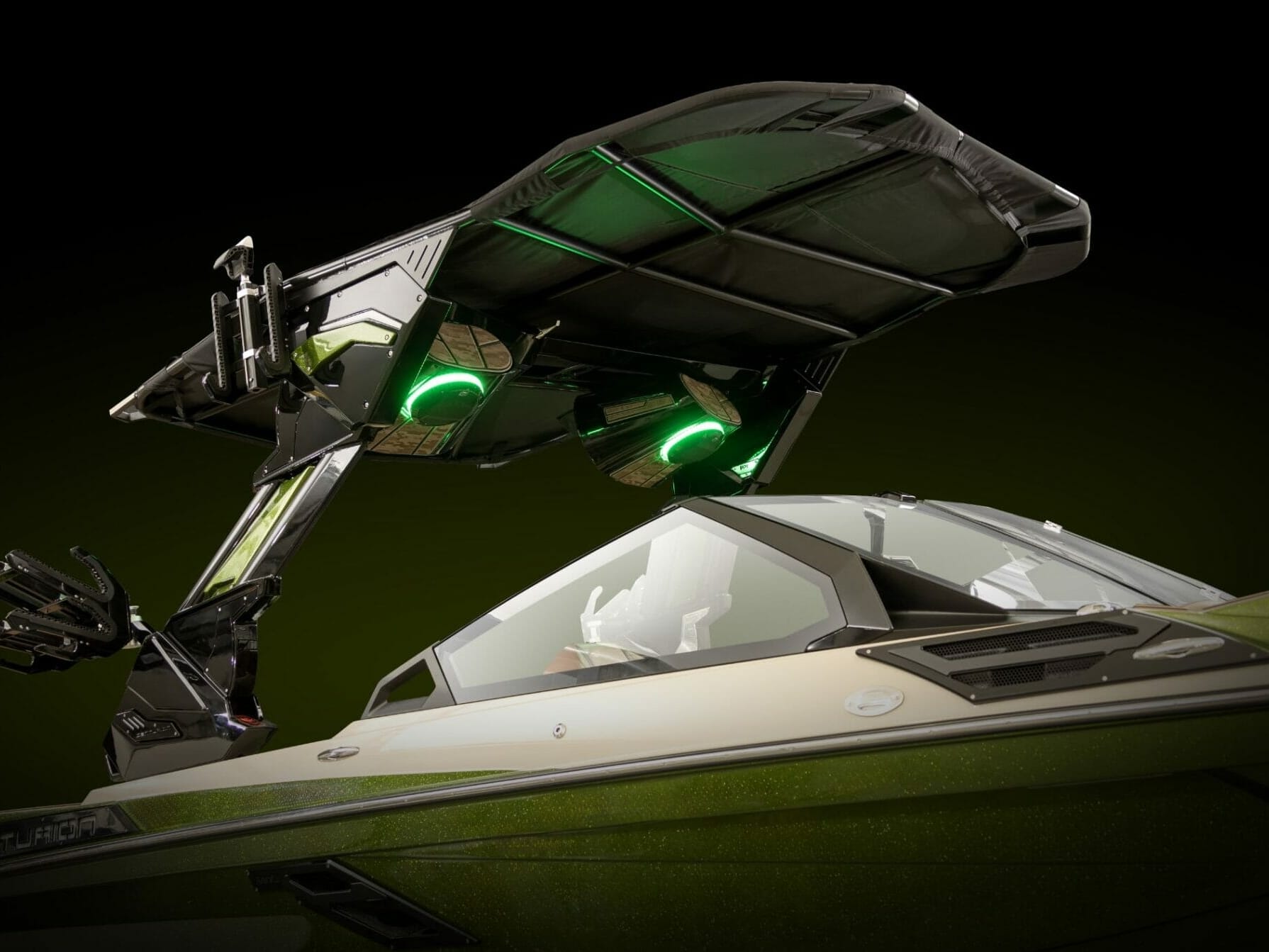 A wakesurf boat with lights on top of it.
