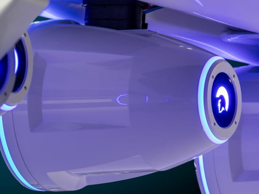 A close up of a futuristic airplane with blue lights.