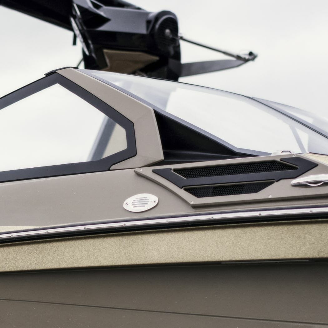 A close up of a wakesurf boat with a windshield.