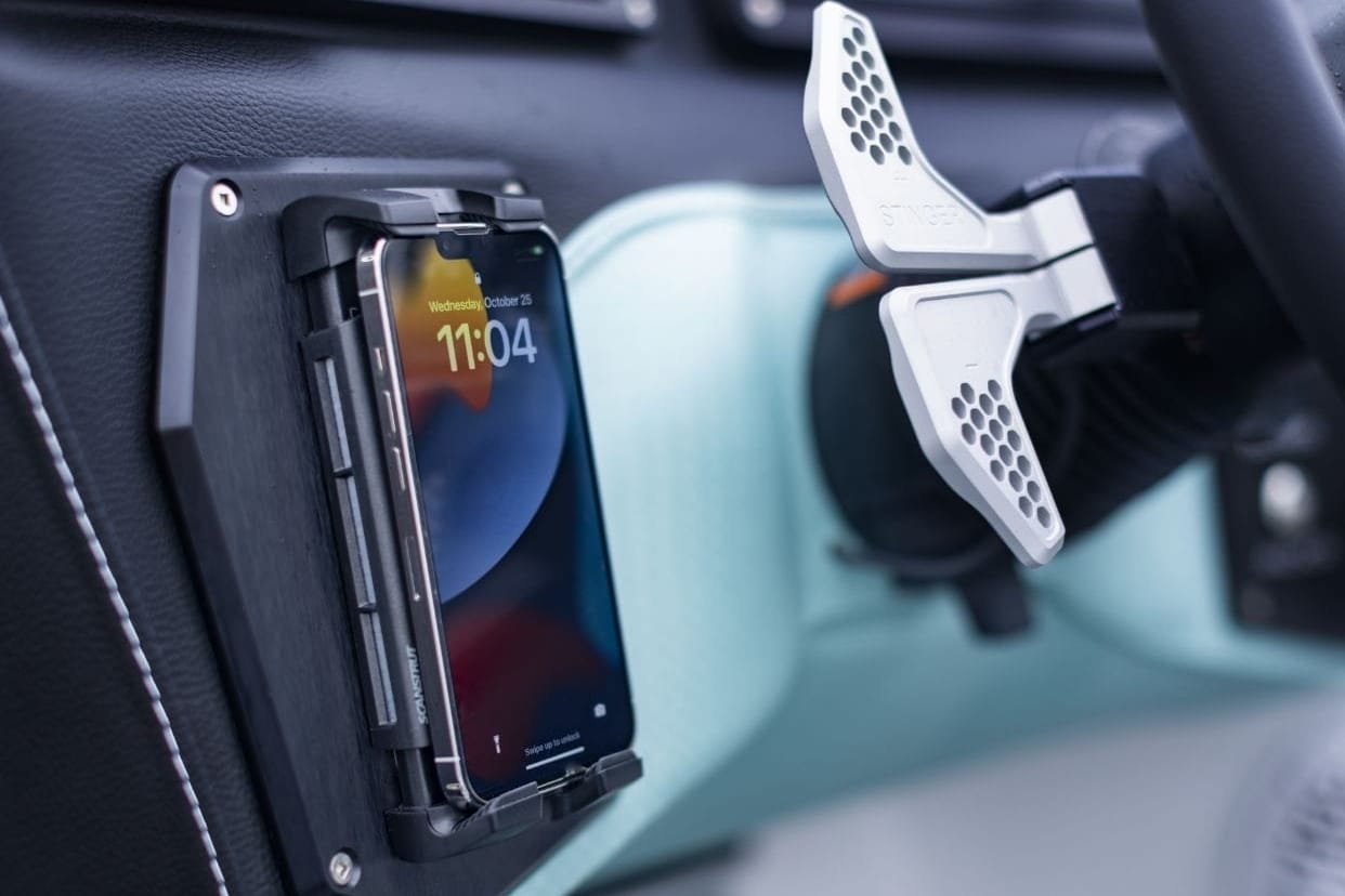 A Centurion phone holder in the dashboard of a car.