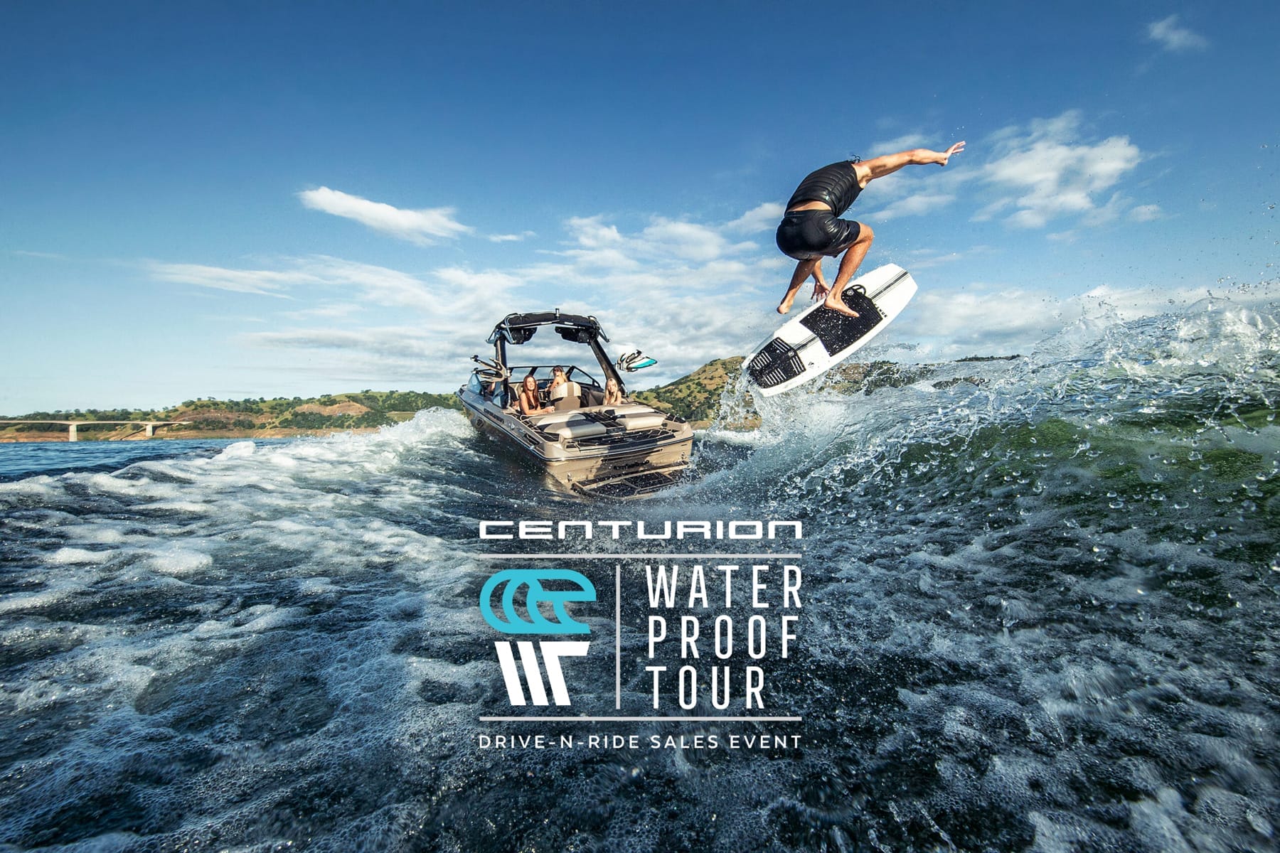 A person wakeboarding with a stylized jump next to a moving boat on a sunny day, with the "centurion waterproof tour" logo displayed at the bottom.