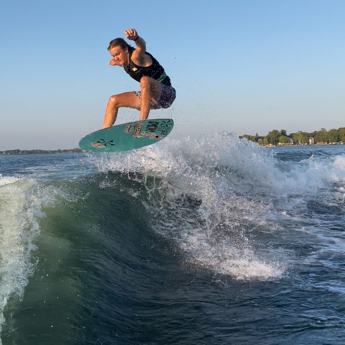 Cade Lybeck riding a wave on a surfboard.
