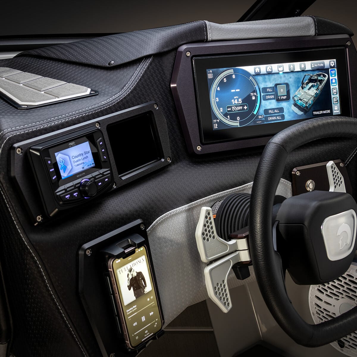 Dashboard of a modern vehicle featuring a digital display, various controls, a mounted smartphone, and a steering wheel with a small screen in the center.