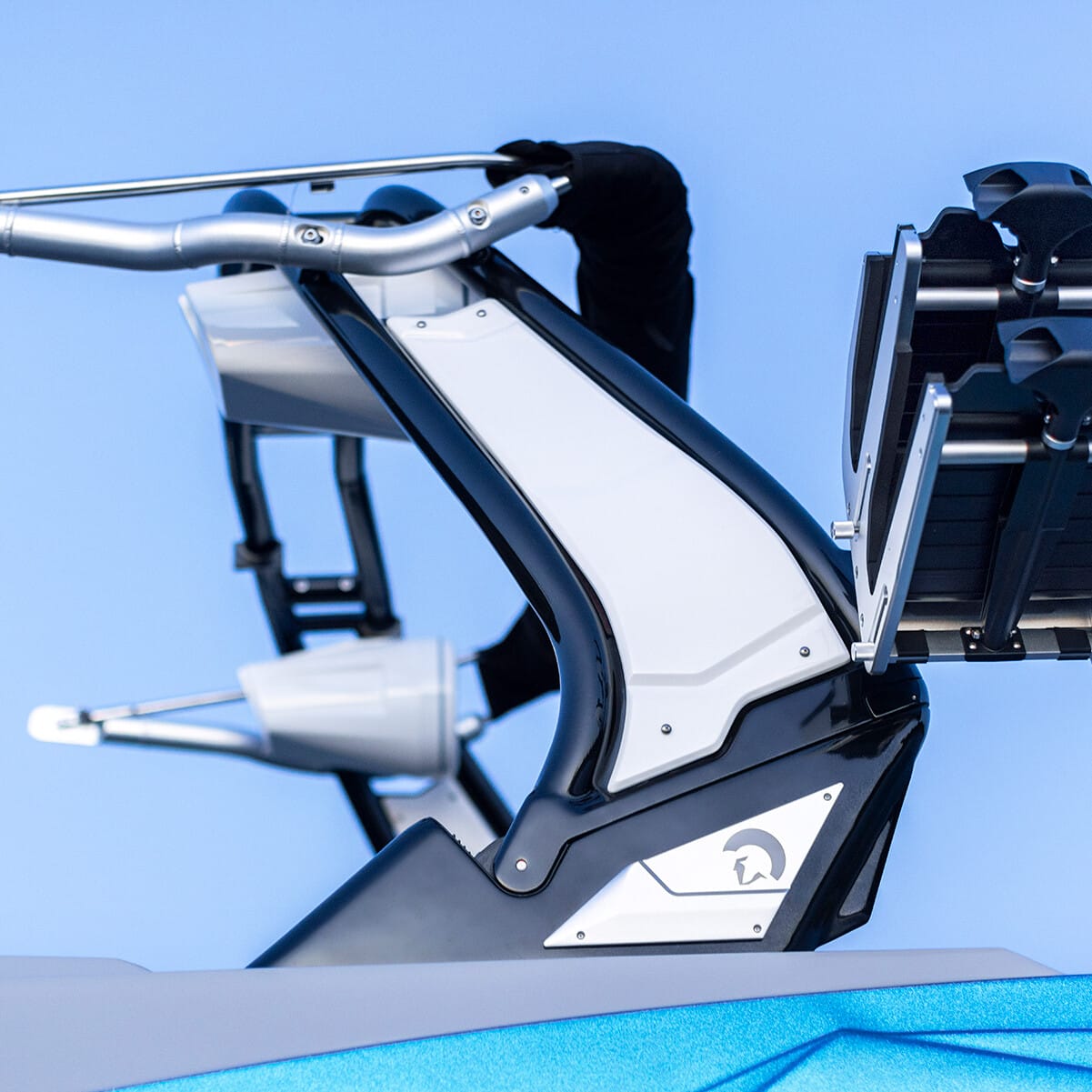 Robotic mechanical arm with a sleek white and black design, positioned against a clear blue background.