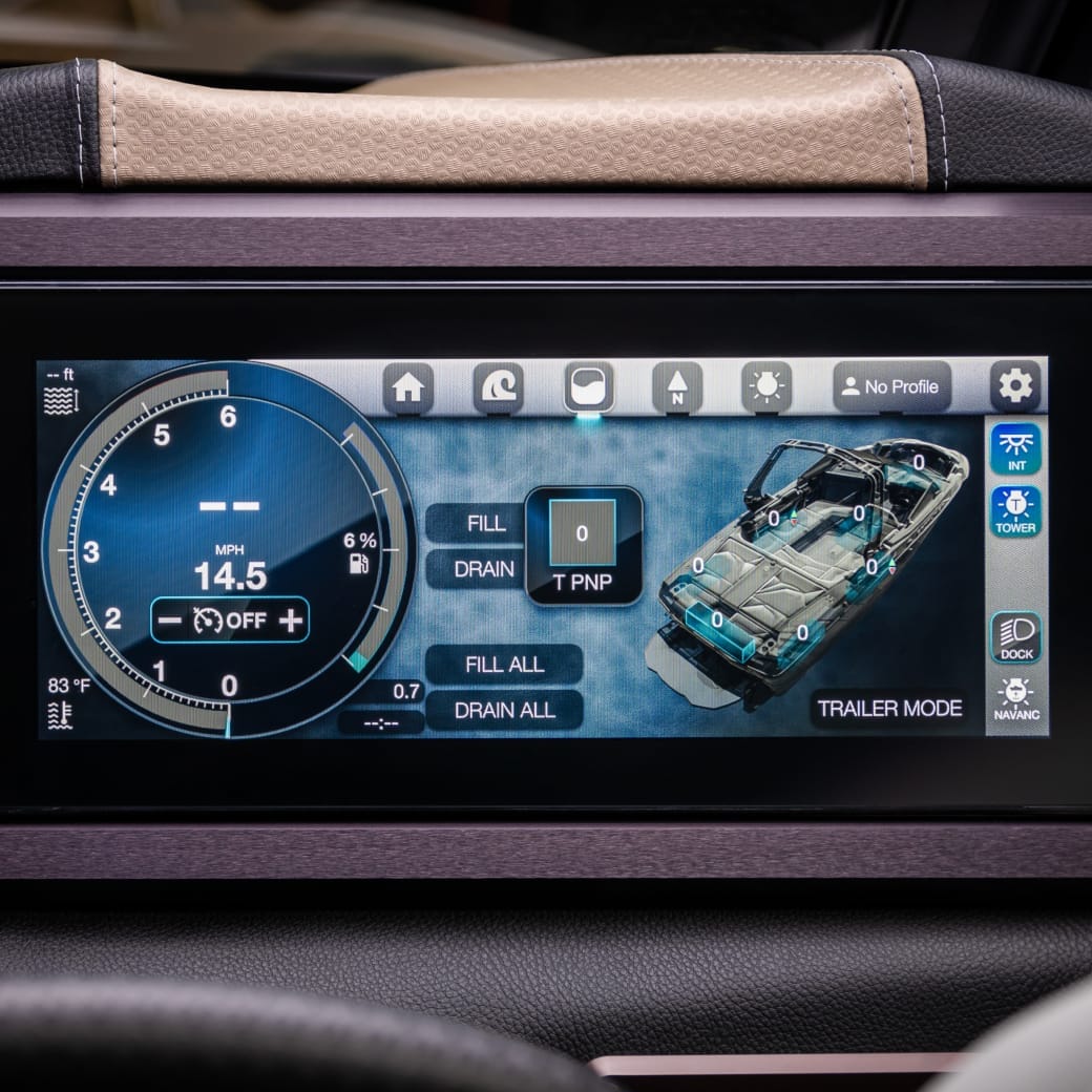 Close-up of a car dashboard screen showing various controls, including speed, fill and drain options, a trailer mode display, and other icons for settings and features.